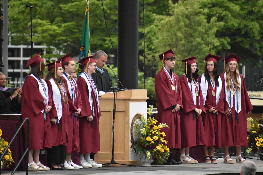 Valedictorians and the class salutatorian assemble on stage during graduation.
