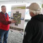 King County’s Community Partnerships and Grants Program manager Scott Thomas talks to a couple locals about the proposed tree cutting plan on Mt. Peak before the official presentation. Photo by Ray Miller-Still