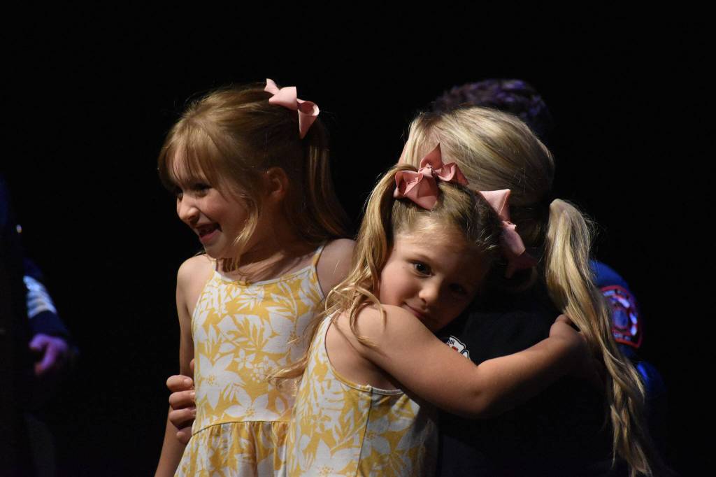 Amanda Simone, pinned during the graduation ceremony, shares a huge with her family.