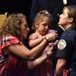 Graduating recruit Kelcie Gahley is pinned by her family during the ceremony.