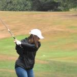 PHOTO BY KEVIN HANSON
The greens and fairways were turned crimson and gray on a Saturday morning in 2021 when the Enumclaw Golf Course played host to a tournament that raised money for the WSU wrestling program. Above, Heather McCann begins with a drive down the first fairway. She was one of 37 participants who helped generate $13,500 for the Cougar program that year. Aside from players, money came from 20 businesses and individual sponsors, an auction of 28 donated items and the sale of WSU wrestling T-shirts. Phil Burnett, who coaches the WSU team, is an Enumclaw resident.