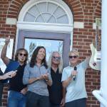 The members of rock band REO Speedwagon stand at the steps of Enumclaw City Hall. Photo by Alex Bruell.