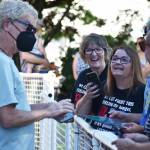 REO Speedwagon lead singer Kevin Cronin chats and signs memorabilia with fans outside Enumclaw City Hall. Photo by Alex Bruell.