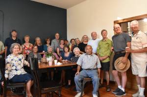 Photo by Alex Bruell 
Carl Lee sits for a photo with the friends hes made over the years at the Buckley Food Bank and Buckley Kiwanis Club.