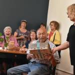 Photos by Alex Bruell 
Carl Lee is handed a gift by Food Bank Facility Manager Donna Garland.
