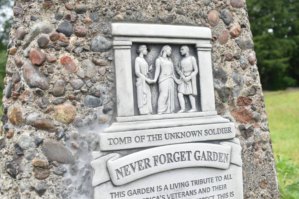 A closeup of the artwork featured in the Never Forget Garden plaque. Photo by Alex Bruell.