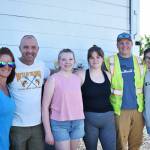 Photo by Alex Bruell 
From left to right: Shannon Jones Slish, Grant Slish, and their high school volunteers Jane Tague, Jillian Tague, Jackson Tague and Soleil Bianchi pose for a photo after a busy afternoon of preparing and doling out food for families in the Buckley community.
