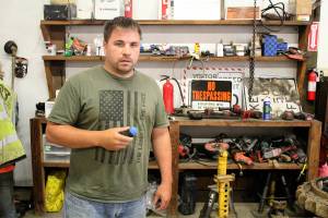 Jason Wood holds up one of the "rubber bullets" left behind from when deputies arrested Aaron Ray Lincoln on July 12. Photo by Ray Miller-Still