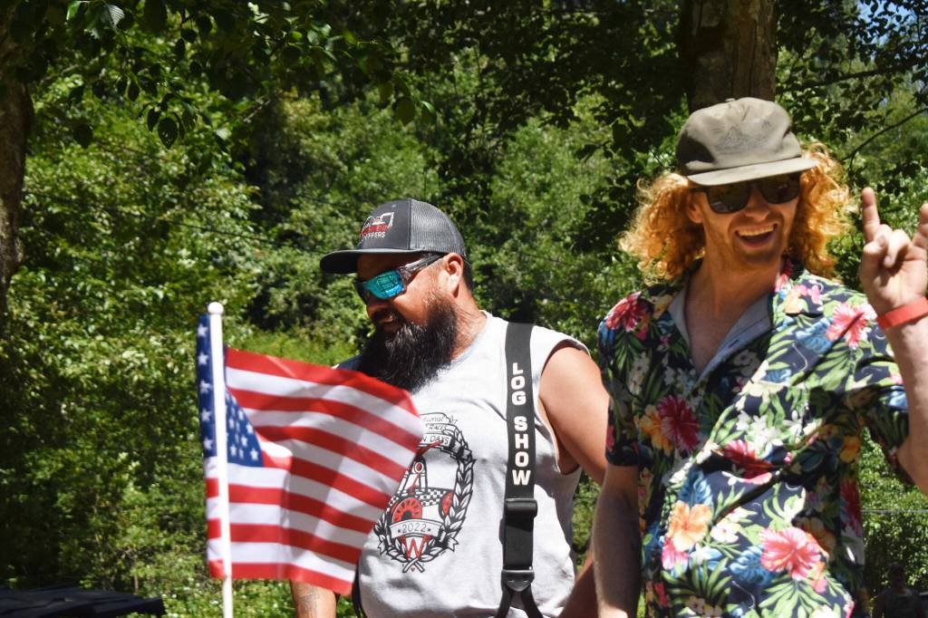 A pair of racers celebrate and catch their breath after making a run on the handcars. Photo by Alex Bruell