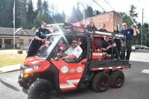 Assistant Chief Johan Olson and other Buckley firefighters pose for a picture on the new side-by-side.