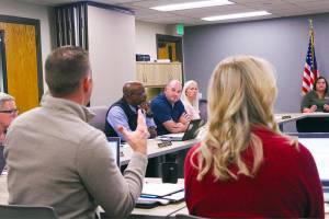 Photo by Ray Miller-Still 
Enumclaw School District Business Director Kyle Fletcher presents additional bond data to the school board and Superintendent Dr. Shaun Carey.