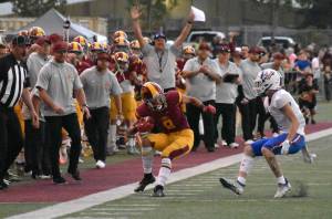 Photo by Kevin Hanson 
The Enumclaw High sideline was celebrating early Friday night when Bo Dods intercepted a pass, setting up the Hornets first touchdown.