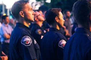 Photos by Ray Miller-Still 
Dozens of first responders, from local police officers, EMTs, and firefighters to even state patrol troopers, attended a memorial dedication ceremony last Tuesday, Sept. 20. Many city officials, staff, and community members also attended, including Penny and Lucy Chevassus, seen here sitting on the blue bench.
