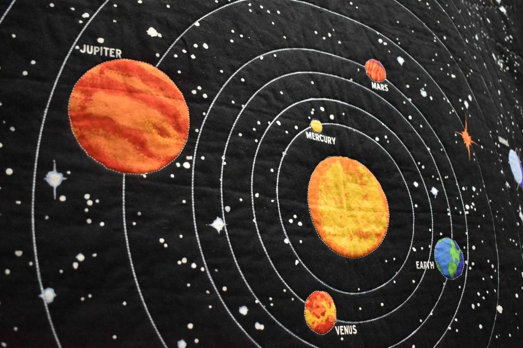 Pictured is a quilt titled Planets, a piece purchased from a Wyoming store and quilted with glow-in-the-dark thread by owner Linda Bowman. Photo by Alex Bruell