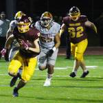 The Enumclaw and White River Hornets met on the gridiron last Friday for the annual Battle of the Bridge. EHS emerged from the melee as the apex insect, but WRHS was able to get a few good stings in. Pictured is WRHS' Jacob Rennaker making a break after completing a pass from Aaden Rathbun. Photo by Ray Miller-Still