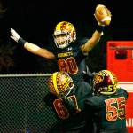 Celebrating a second-half touchdown reception is Karson Holt, getting a boost from linemen Zeke Luchi (67) and Will Harper (55). Photo by Kevin Hanson