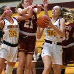 White Rivers Vivian Kingston pulls down a rebound as she and teammate Josie Jacobs (24) crash the boards during a battle last season against Enumclaw.