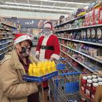 Contributed photo 
Santa joined the Enumclaw Food Bank in shopping for food and other necessities at WalMart last year, with money raised by Johnathan Monson and Dirty2Dreamy.