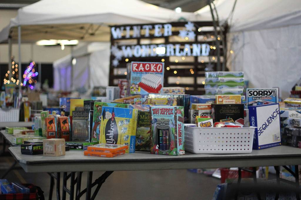 The Enumclaw Expo Centers Les Schwab Hall was filled with all manners of toys, games, and books for all ages last weekend as Plateau Kids Network volunteers like Tanna Bunker, pictured, put together shopping bags for local families based on their kids gift likes and preferences. Photos by Ray Miller-Still