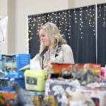 Photo by Ray Miller-Still 
The Enumclaw Expo Centers Les Schwab Hall was filled with all manners of toys, games, and books for all ages last weekend as Plateau Kids Network volunteers like Tanna Bunker, pictured, put together shopping bags for local families based on their kids gift likes and preferences.