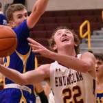 PHOTOS BY KEVIN HANSON The Plateaus boys basketball teams rolled to victories Friday (Dec. 16) night, both playing host to South Puget Sound League 2A opponents. Helping his Enumclaw High team to a victory over the Fife Trojans was senior Ty Hanson (22), shown here working to score under the basket; in the Buckley gym, junior Tyce Donovan (11) races past a Clover Park defender.