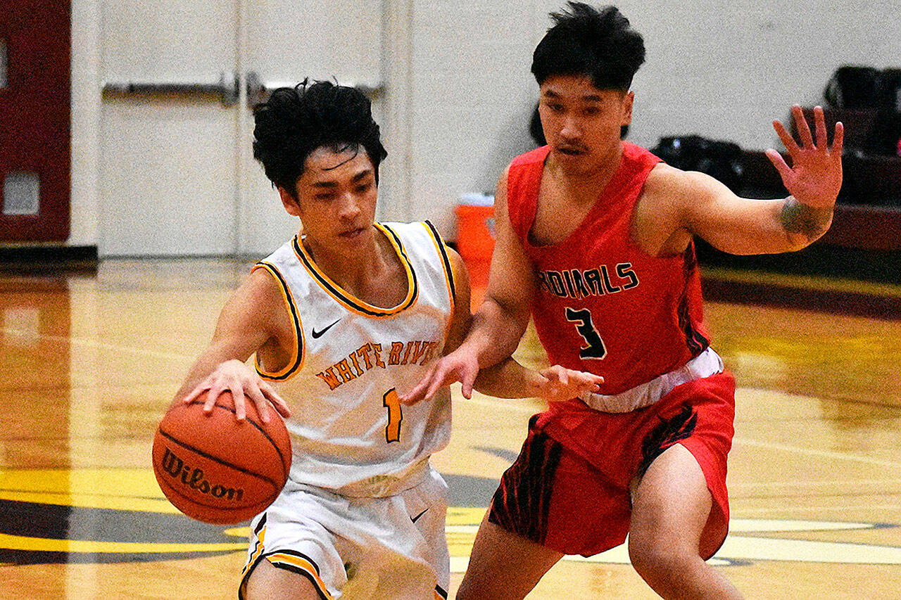 The White River High gym was home to a Friday night doubleheader between the Hornets and the visiting Franklin Pierce Cardinals. White River won both ends, the boys in a squeaker and the girls in a blowout. In these boys photos, Jacob Du (1) drives past a Cardinal defender. Photo by Kevin Hanson