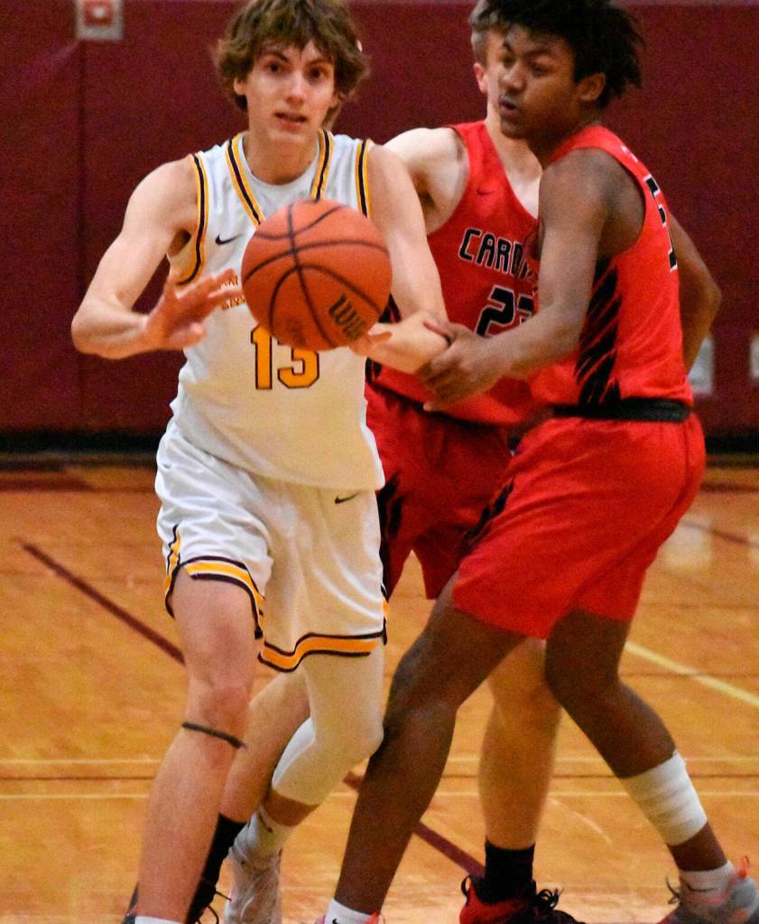 Rylan Ramos (13) passes to an open teammate. Photo by Kevin Hanson