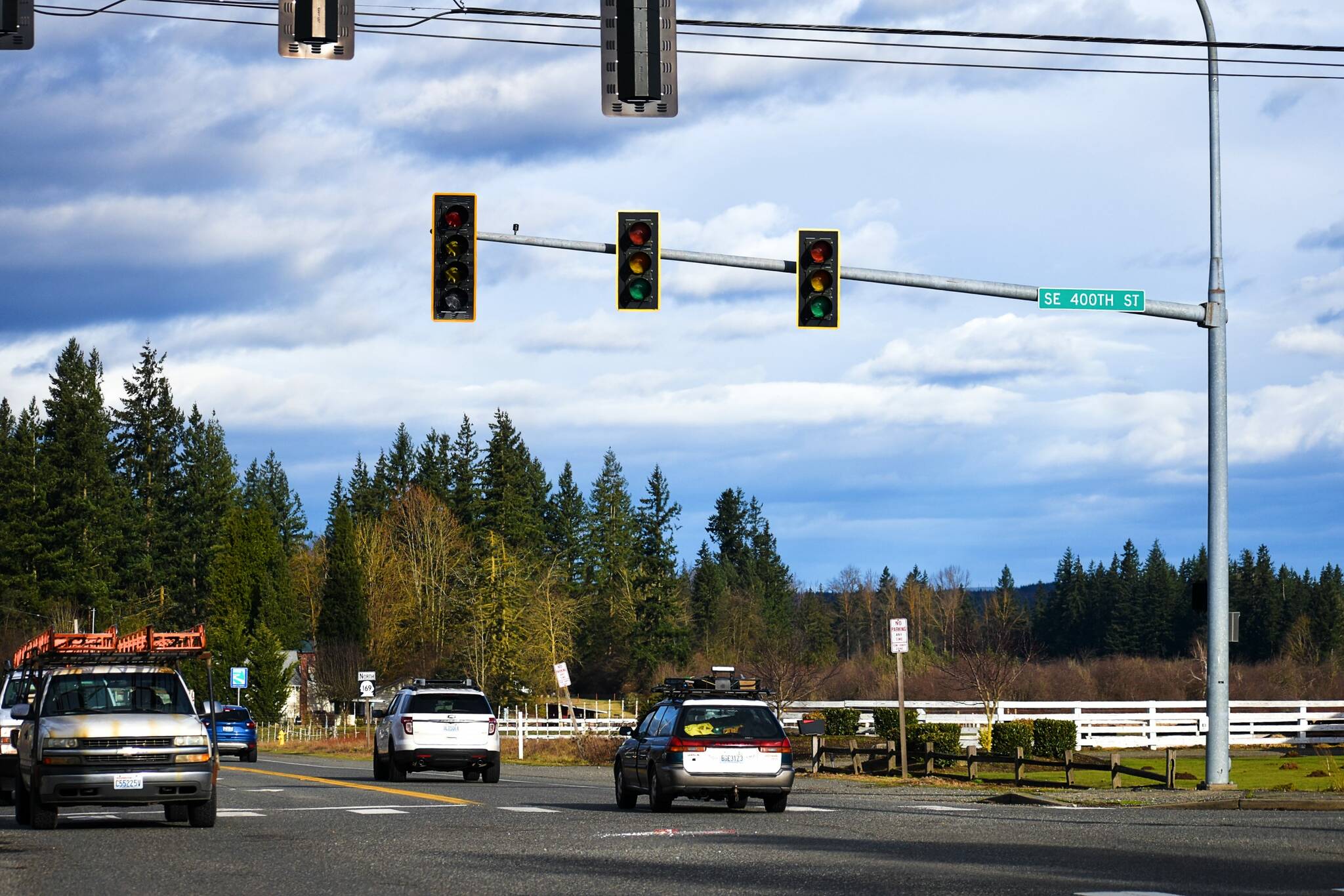 Drivers negotiate the Krain intersection without power Monday morning after a major windstorm knocked out power across much of the Plateau Jan. 9. In Enumclaw, tossed-around trash and recycling bins and downed branches signaled the effects of the angry winds. Photo by Alex Bruell.
