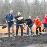 Jiminez, Dammeier, Constantine, Reynolds, Johnson, and Miles executing the ceremonial groundbreaking at the Foothills Trail bridge construction site on the Buckley side of the river. Photo by Ray Miller-Still
