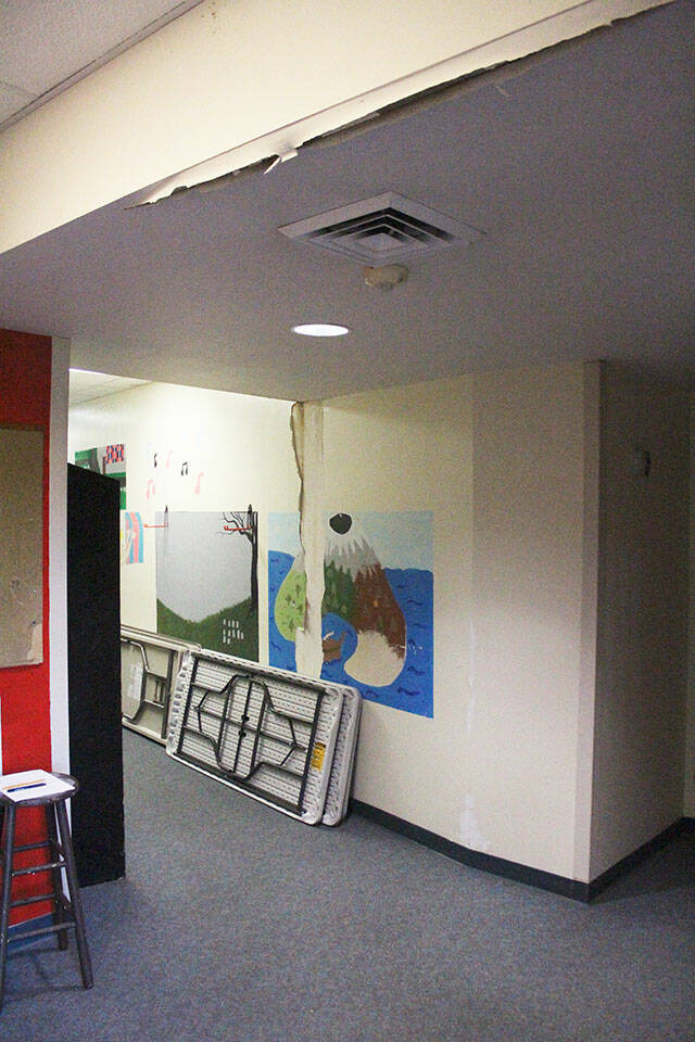 There were no buckets catching leaks when this photo was taken, but you can see the water damage that has eroded the ceiling and walls around the auditorium. Photo by Ray Miller-Still