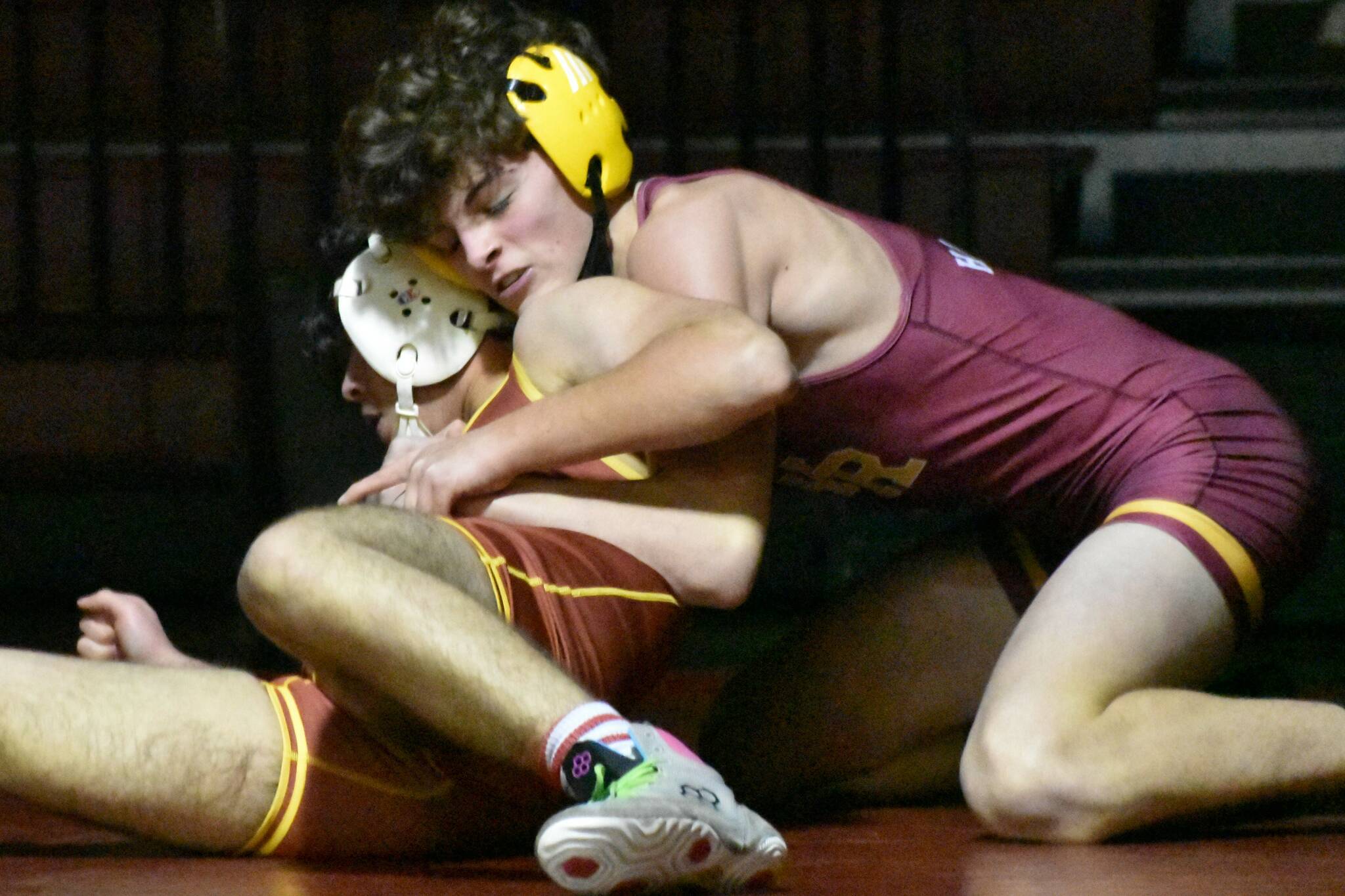 The White River High boys wrestling team hosted Enumclaw and Franklin Pierce on Jan. 18, defeating both South Puget Sound League 2A opponents. In these photos, WRs Hunter Oswold (yellow headgear) gets the better of his EHS opponent. Photo by Kevin Hanson