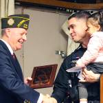 Officer Trevor Pourchot and his daughter. Photo by Ray Miller-Still