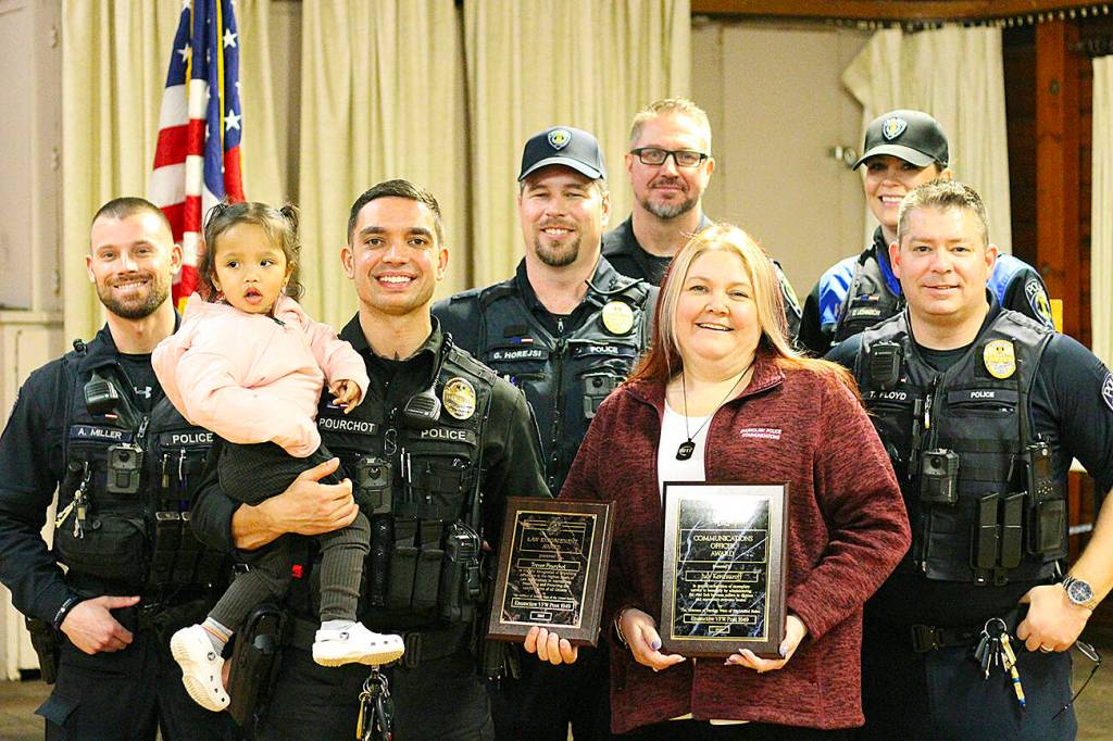 Officer Pourchot and dispatcher July Kenezuroff (maroon). Photo by Ray Miller-Still