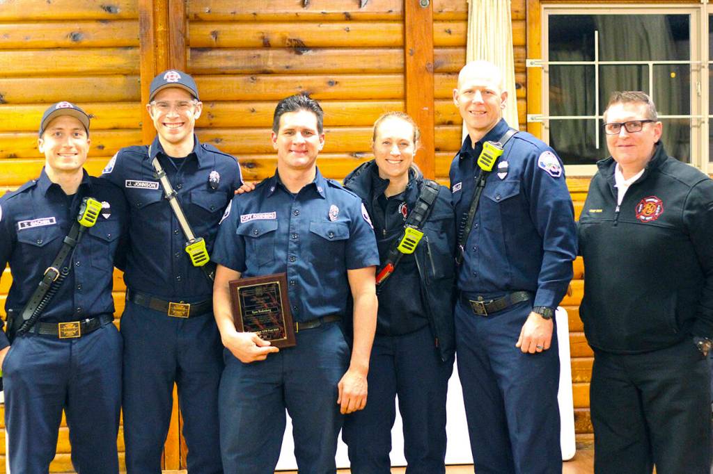 Firefighter Ryan Rodenberg (middle). Photo by Ray Miller-Still