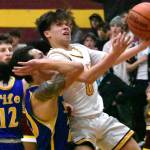 Logan Senon (0) is fouled as he drives through the lane. Details from both games can be found in Sports Roundup. Photo by Kevin Hanson
