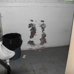 The away bathrooms under the Expo Center Fieldhouse, like the locker rooms, are dark, small, and in disrepair. Photo by Ray Miller-Still