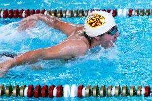 Swimmers from Enumclaw and White River high schools wrapped up the regular season Jan. 31 with a successful home meet against a combined Franklin Pierce/Washington squad. In this photo, Enumclaws Rishi Burt (white cap) competes in the butterfly leg of the medley relay. Photo by Kevin Hanson