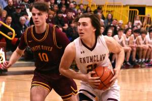 PHOTOS BY KEVIN HANSON
The hoop edition of the Battle of the Bridge was played out over the course of two nights last week. The Hornet-Hornet girls' game was contested Thursday and the boys tussled the following evening; both victories went to the home-court Enumclaw teams. In these photos, Enumclaw's Karson Holt drives to the hoop and White River's Dakota Sprouse does the same.
