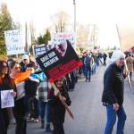 After waving at passing cars, the group of protestors eventually moved to march in front of the house off 188th Avenue. Photo by Ray Miller-Still