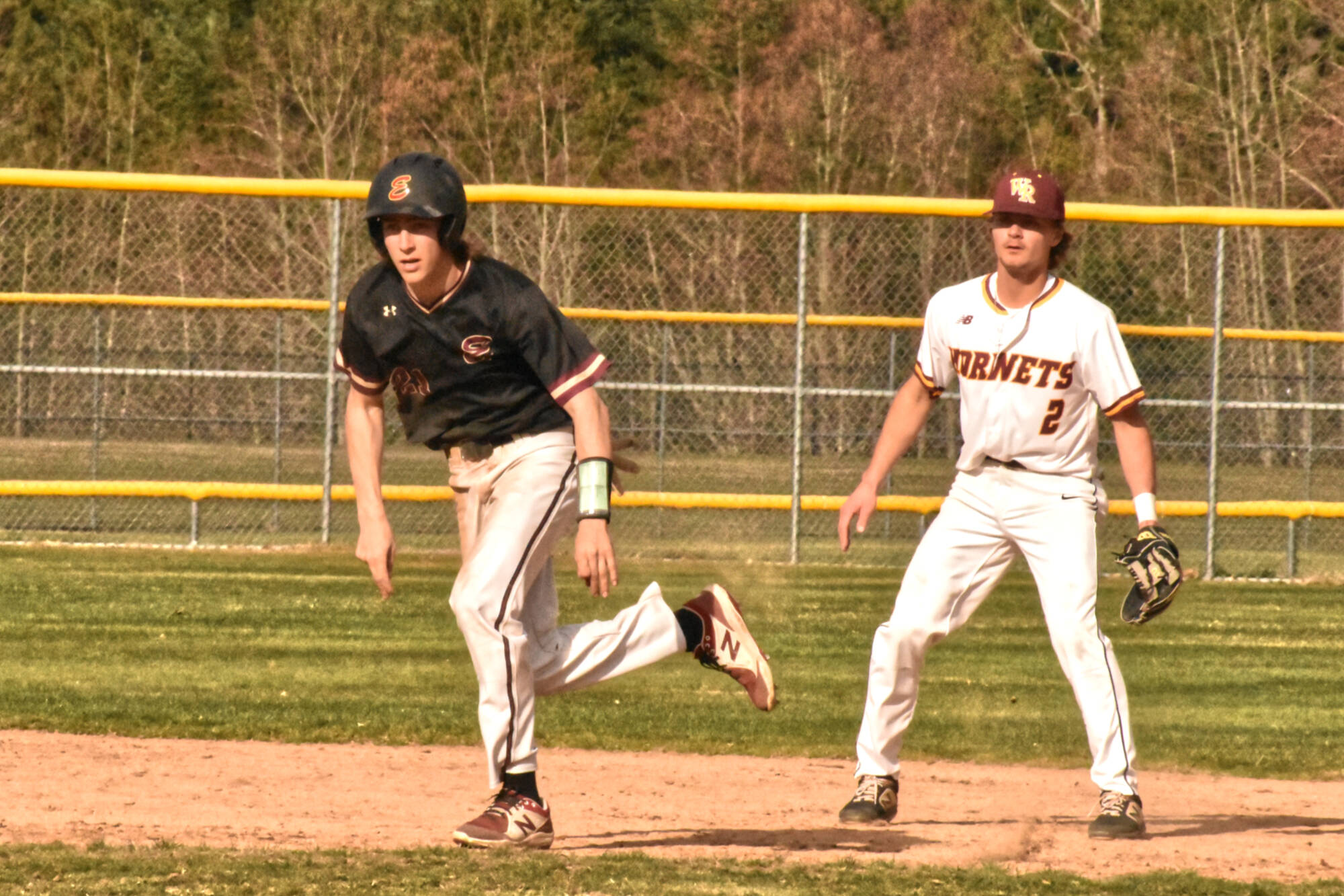 PHOTO BY KEVIN HANSON The baseball version of the Battle of the Bridge played out over the span of two days last week (March 28 and 29) and saw the Enumclaw Hornets take victories in both SPSL 2A games. Here, Enumclaw junior Karson Holt gets a good lead off second base while White River shortstop Ty Jacobs guards the bag. The action came midway through the Wednesday contest that resulted in a five-inning, 11-1 victory for EHS.