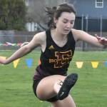 After taking a brief hiatus for spring break, the Enumclaw High track and field crew returns to action with a road meet against the Orting Cardinals. Action gets under way at 3:30 p.m. Thursday at Cardinal Stadium. Among the regulars who represent EHS are Saiya Flaherty in the hurdles and Michael Poleski (left) and Jack Heise, both members of the boys relay squad. These photos came during the Hornets last home meet. Photos by Kevin Hanson/For the Courier-Herald
EHS Saiya Flaherty in the hurdles. Photo by Kevin Hanson/For the Courier-Herald
