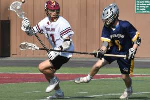 Photo by Kevin Hanson 
The Enumclaw Hornets will play for a state 2A championship Saturday at the Starfire Sports Complex in Tukwila. The highly-successful Hornets opened the playoffs with a May 13 victory over Squalicum and advanced to the finals with a May 20 thrashing of Burlington-Edison. Shown here, during Saturdays victory, is Jack Popke (#11). The Hornets had little trouble with Burlington-Edison, winning 22-5, and will face Orting at 10:30 a.m. Saturday for the 2A title.