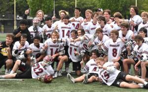 Photos by Kevin Hanson and Todd Overdorf / sonscapeimages.com/home
The Enumclaw High lacrosse team celebrates with a mid-field photo, moments after capturing the 1A/2A state championship. The Hornets took the title with a convincing victory over Orting at the Starfire complex in Tukwila. Pictured here, taken during Saturdays contest, are McCade Walker (#16) maneuvering past an Orting defender; and Colton Paulson diving toward the goal through three Orting players.