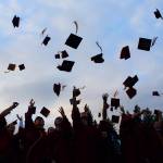 The graduates toss their caps at the close of the ceremony. Alex Bruell / Sound Publishing.