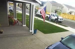 Screenshot
Security footage from May 1, 2021, shows Jonathan Arnold, on the right, approaching a woman in purple, who backs away with her arm out in front of her. According to a police report, the woman backed up all the way to her front door, which was when Arnold grabbed her hand.