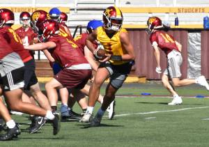 PHOTOS BY KEVIN HANSON 
Temperatures might be sticking to a summer schedule, but the fall sports season has kicked off throughout the state of Washington. Football teams began turnouts a week ago (August 16) and all other sports began practicing Monday of this week. These photos were taken Friday at the Enumclaw Expo Center and on the White River campus. Above, Enumclaws returning quarterback Gunnar Trachte prepares to hand off during the no-pads scrimmage, while head coach Mark Gunderson works on defensive schemes with the teams No. 2 crew. Below, new White River coach Wyatt Evenson runs the offense through drills while, on another part of the field, lineman go through their hand-to-hand paces. Previews of this years Hornet programs - both Enumclaw High and White River - will appear in the Aug. 30 edition of the Courier-Herald. Both teams open the season with home games on Aug. 31. Previews of the other fall sports will follow in the issue of Sept. 6.