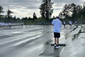 The Panthers earlier 3-2 victory over the Lancers couldnt be replicated as they narrowly fell 2-3 in this gripping rematch. Pictured is Andrew Neman sweeping up the water on the courts. Photo by Andy Orozco