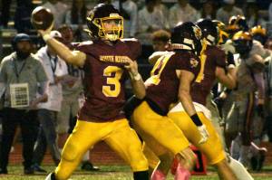 Photos by Kevin Hanson
The White River High football team has reversed an early-season losing skid and has now won four games in five weeks. These photos are from the Hornets Oct. 19, home-field victory over the Fife Trojans: standing strong in the pocket while receiving solid protection from his line, quarterback Aaden Rathbun prepares to send a pass downfield.