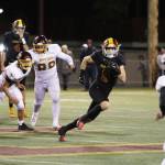 The Enumclaw and White River High Hornets met at the Enumclaw Expo Center to dual it out in the annual Battle of the Bridge game. The night was cold, but the action was hot, especially in the first quarter, which saw EHS post the first touchdown within the first 15 minutes of the night; WRHS returned the favor a quarter of an hour later. Pictured is No. 9 Wyatt Neu speeding to the edge for another Enumclaw first down and No. #80 Karson Holt completing another touchdown. For more information, head to page 6. Photos by Todd Overdorf/SonScape Images