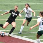 Photo by Kevin Hanson
Enumclaw junior Ally Mavin, under pressure from a pair of Roughriders, prepares to launch a pass downfield during Saturdays District 2/3 match at the Expo Center.